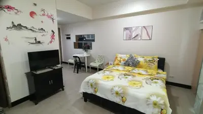 a bedroom with a bed and a flat screen tv at Condotels Near Terminal 3 Airport in Manila