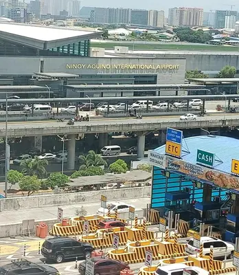a view of a parking lot with cars and a freeway at Condotels Near Terminal 3 Airport in Manila