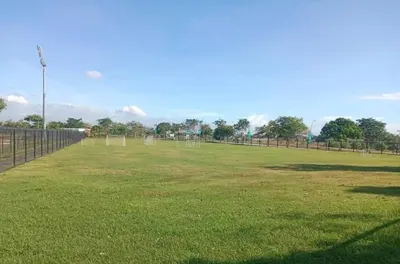a large field with a fence and a soccer field at Athlete's House in Imus