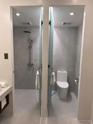 a bathroom with a shower and a toilet in it at Athlete's House in Imus