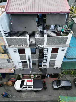 an aerial view of a building with cars parked in front at SB LODGE TAGUIG in Manila