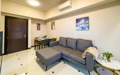 a living room with a couch and a table at Cityscape View 2BR in Uptown BGC w 200mbps WiFi in Manila