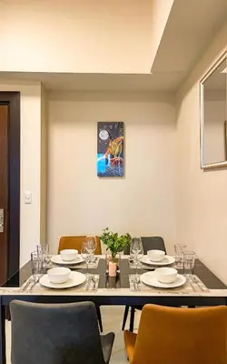 a dining room with a table and chairs at Cityscape View 2BR in Uptown BGC w 200mbps WiFi in Manila