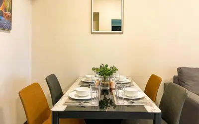 a dining room table with chairs and a dining room table at Cityscape View 2BR in Uptown BGC w 200mbps WiFi in Manila