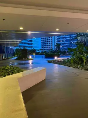 a bench in a building with a city at night at Royal Victorian Studio in Makati in Manila