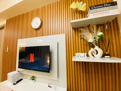 a bathroom with a sink and a tv on a wall at S Residences Condo PoolView Balcony in SM MOA near NAIA in Manila