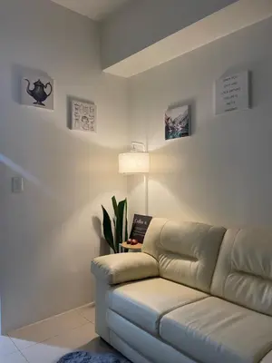 a living room with a couch and a lamp at SMDC Jazz Residences Makati City Philippines in Manila