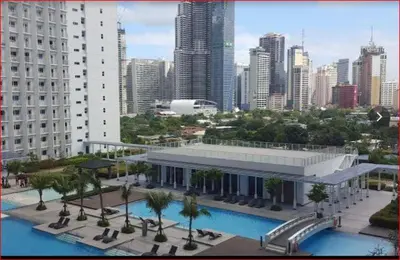 a large building with a swimming pool in a city at SMDC Jazz Residences Makati City Philippines in Manila