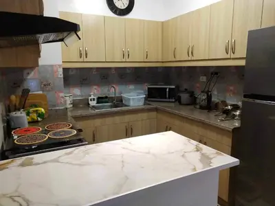 a kitchen with a marble counter top and a stove at ALEA RESIDENCES Condo near Airport and MOA! Cozy Place with Main street and Manila Bay view in Manila
