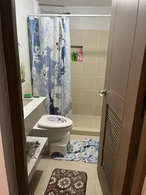 a bathroom with a toilet and a shower at ALEA RESIDENCES Condo near Airport and MOA! Cozy Place with Main street and Manila Bay view in Manila