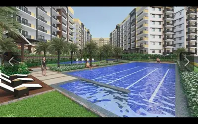 a large swimming pool in front of some buildings at ALEA RESIDENCES Condo near Airport and MOA! Cozy Place with Main street and Manila Bay view in Manila
