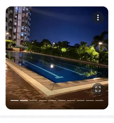 a swimming pool in a city at night at ALEA RESIDENCES Condo near Airport and MOA! Cozy Place with Main street and Manila Bay view in Manila