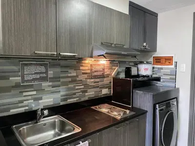 a kitchen with a sink and a dishwasher at Lovely 1 bedroom at Vista Shaw Residences in Manila