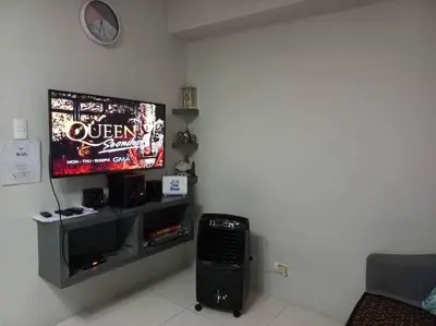 a living room with a television and a keyboard at Lovely 1 bedroom at Vista Shaw Residences in Manila