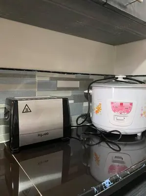 two appliances are sitting on a counter top at Lovely 1 bedroom at Vista Shaw Residences in Manila