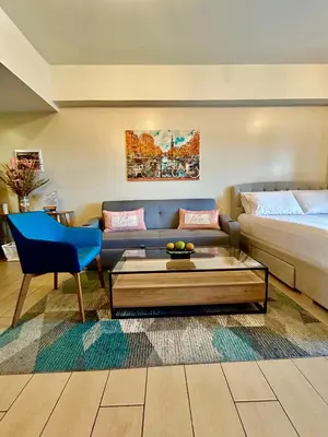 a living room with a couch and a coffee table at BGC, Luxe McKinley Condo at Venice Residences, Free Parking and WiFi in Manila