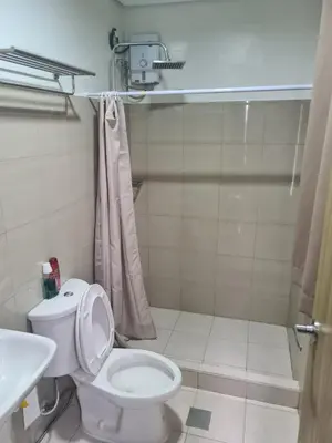 a bathroom with a toilet and a sink at SHORE 2 Res TOWER 1 -2 BR unit in Manila