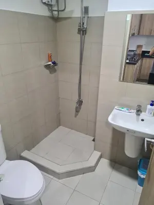 a bathroom with a shower and a toilet and a sink at SHORE 2 Res TOWER 1 -2 BR unit in Manila