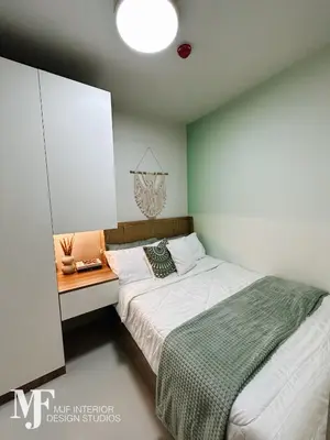 a small bedroom with a bed and a night stand at Mi Casa in Manila