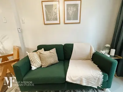 a green couch with pillows in a living room at Mi Casa in Manila