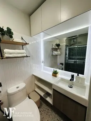 a white bathroom with a toilet and a sink at Mi Casa in Manila