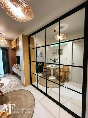 a living room with glass doors and a dining room at Mi Casa in Manila