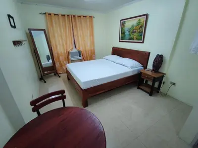 a small bedroom with a bed and a mirror at Lawton Residences Studio Room 2G in Manila