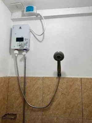 a hose hooked up to a shower in a bathroom at Lawton Residences Studio Room 2G in Manila