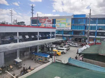 a parking lot in front of a building with cars at Lawton Residences Studio Room 3I in Manila