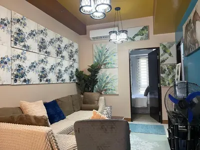 a living room with a couch and a table at Family Staycation, Greenbelt Hamilton, Isabel's Makati Rooms in Manila