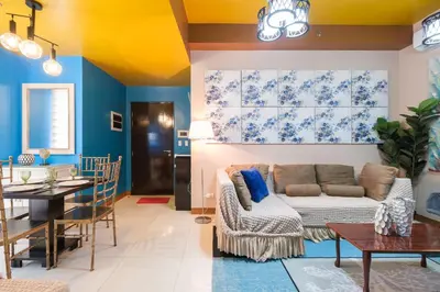 a living room with a couch and a table at Family Staycation, Greenbelt Hamilton, Isabel's Makati Rooms in Manila