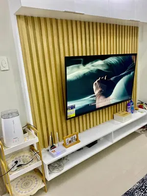 a flat screen tv sitting on top of a wall at Cozyhome by LV & SG - S residences MOA PASAY unit condo in Manila
