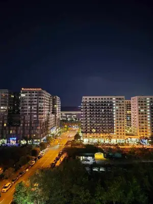 a city lit up at night with tall buildings at Cozyhome by LV & SG - S residences MOA PASAY unit condo in Manila