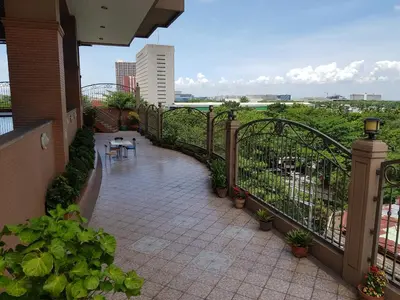 a balcony with a patio with a table and chairs at Hospital ng Manila front delux le mirage de malate in Manila