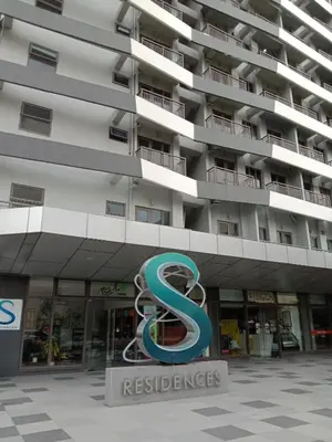 a large building with a s sign in front of it at OASIS CHIC By THE BAY PASAY CITY Near Mall of Asia in Manila