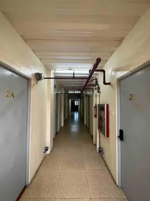 an empty hallway in an office building with a long corridor at Lawton Residences Studio Room 2F in Manila