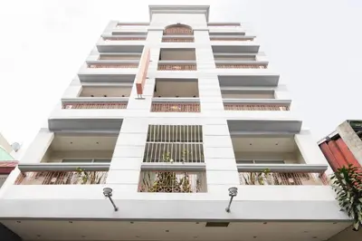 a white building with windows and plants at Starlight Bed and Breakfast in Manila