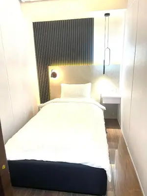 a small bedroom with a bed in a room at E & T Homecations 2 Bedroom Apartment at SMDC Air Residences in Manila