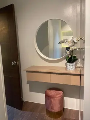 a bathroom with a round mirror and a stool at E & T Homecations 2 Bedroom Apartment at SMDC Air Residences in Manila