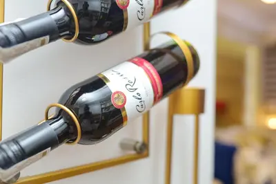two bottles of wine are hanging on a wall at Shore2 Luxurious & Homely Suite near MOA in Manila