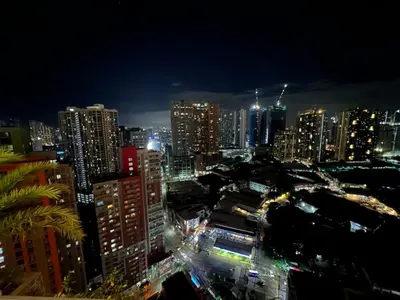 a view of a city at night with lights at Condo in Manila