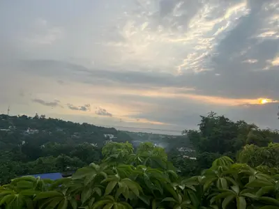 a view of a city from a hill with trees at Sky Haven Staycation in Rizal