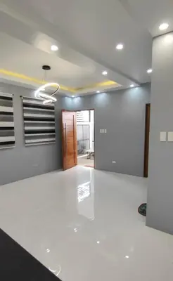 a living room with white floors and a hallway at Sky Haven Staycation in Rizal
