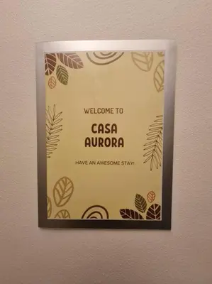 a sign on a wall with a welcome to casa aurora at Beautiful Condo in BGC Taguig - McKinley in Manila