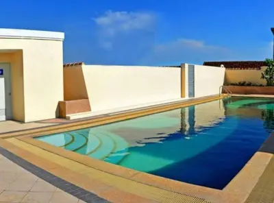 a swimming pool in front of a house at Beautiful Condo in BGC Taguig - McKinley in Manila