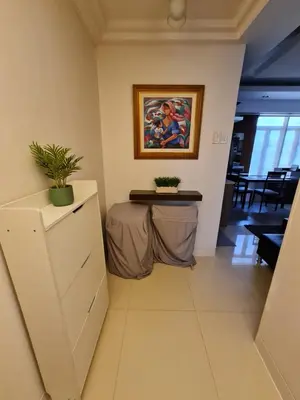 a room with a table and a painting on the wall at Beautiful Condo in BGC Taguig - McKinley in Manila