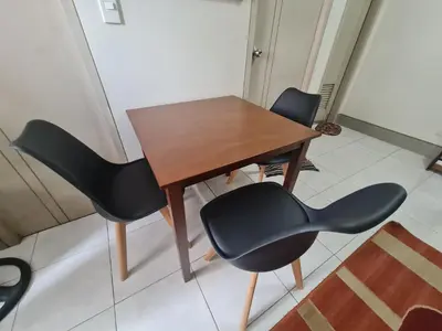 a wooden table and chairs in a room at 1 Bedroom Condo In Little Baguio Terraces, San Juan City in Manila