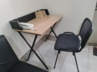 a desk with a chair and a phone on it at 1 Bedroom Condo In Little Baguio Terraces, San Juan City in Manila
