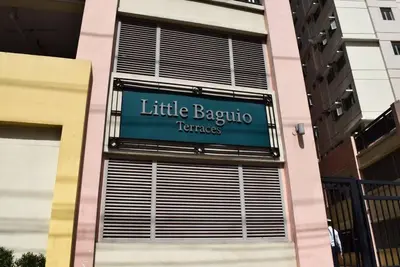 a sign on the side of a building at 1 Bedroom Condo In Little Baguio Terraces, San Juan City in Manila