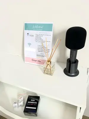 a black chair and a box on a white shelf at Stanford Suites 3 in Silang